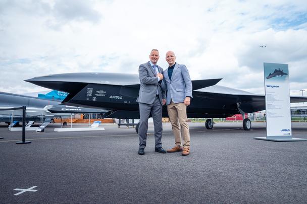 Michael Schoellhorn, CEO at Airbus Defence and Space (on the left), and Gundbert Scherf, Co-CEO at Helsing, in front of the Airbus Wingman model.